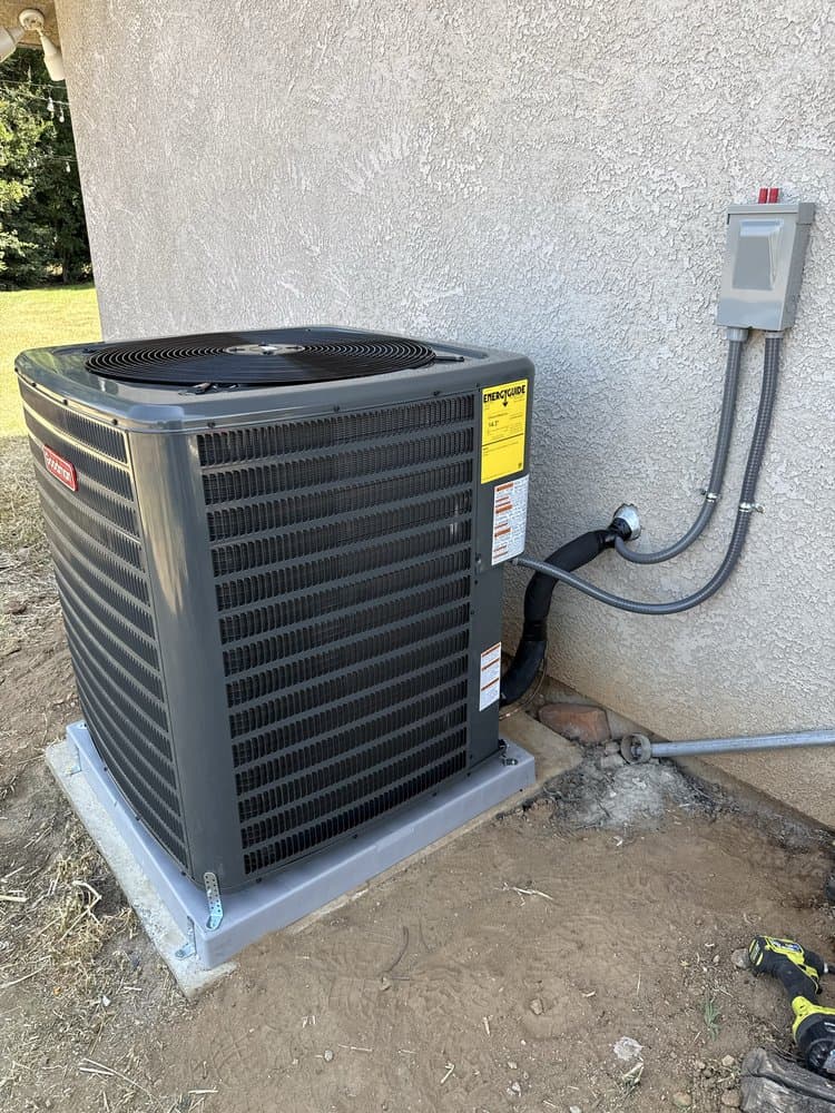 Goodman air conditioner condenser installed beside a home